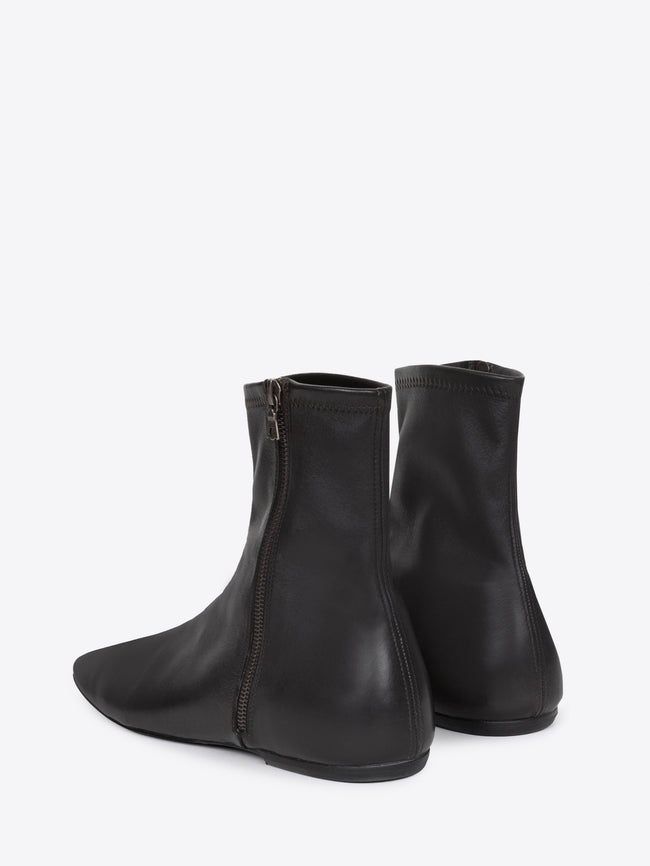 Pair of black leather ankle boots on a white background