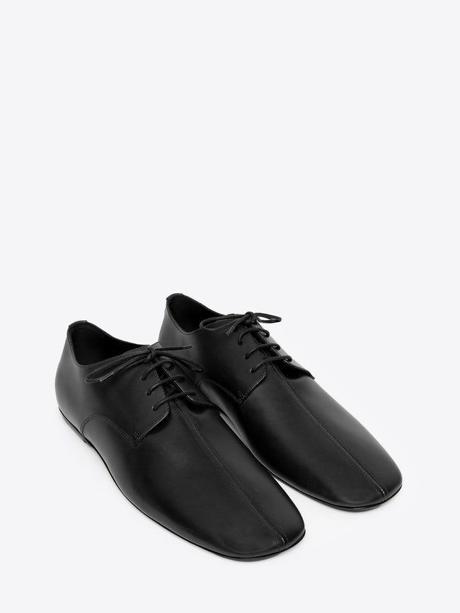 Pair of black leather oxford shoes on a white background