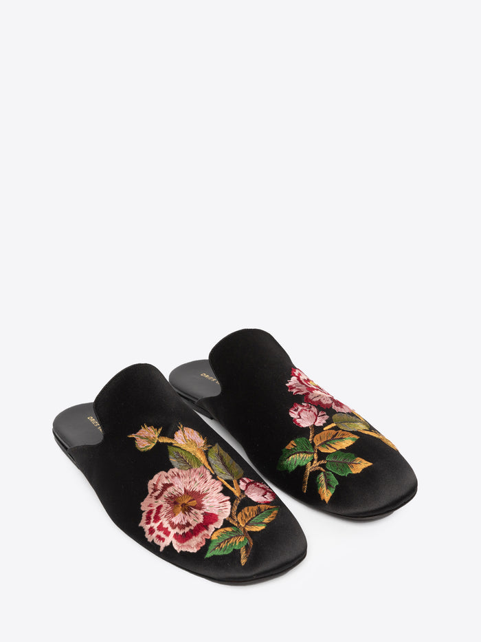 Black slippers with floral embroidery on a white background