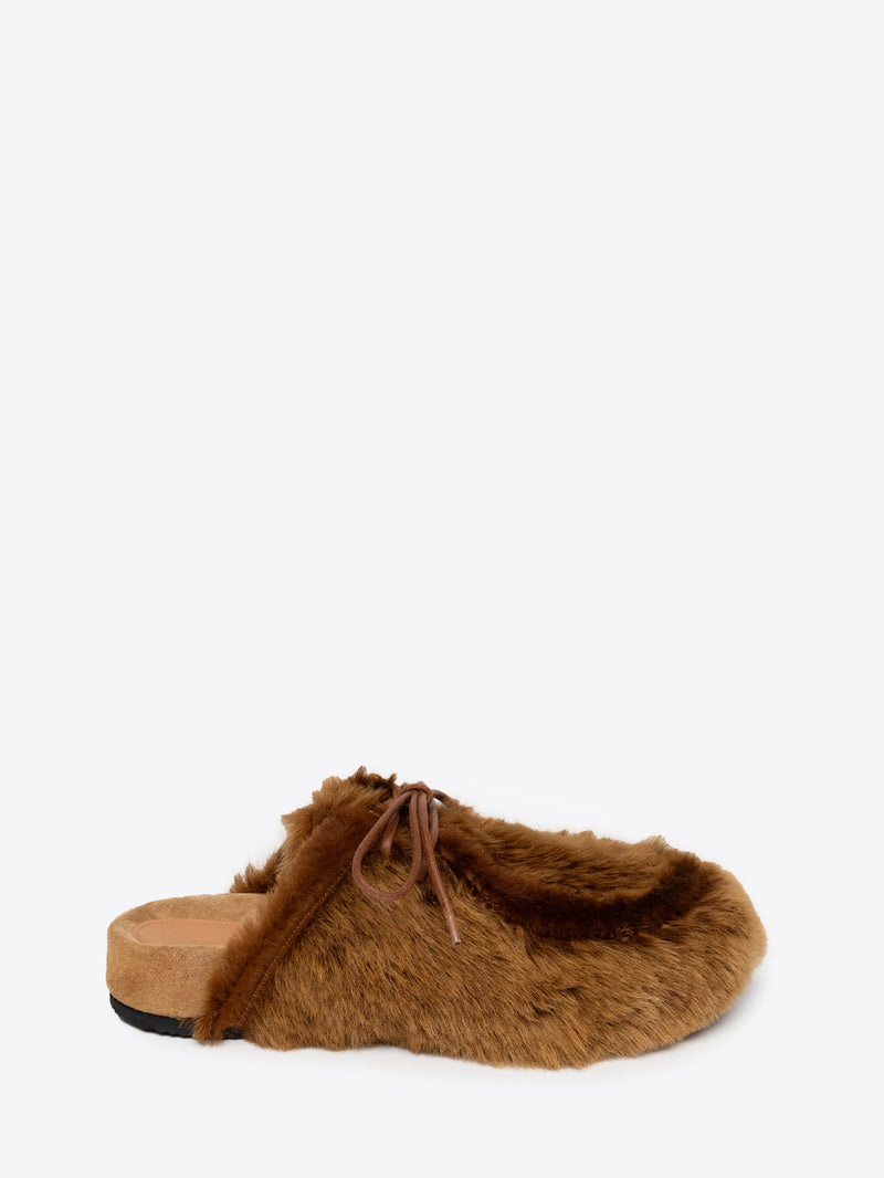 Tan fluffy slipper on a white background