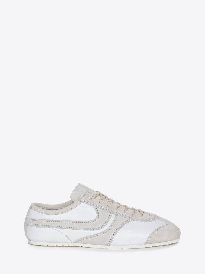 White suede sneaker with beige accents on a white background