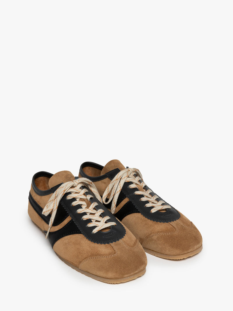 Pair of brown with black accents suede sneakers on a white background