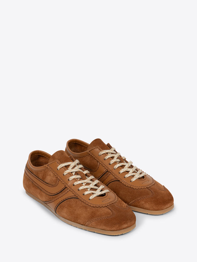 Pair of tan brown suede sneakers on a white background