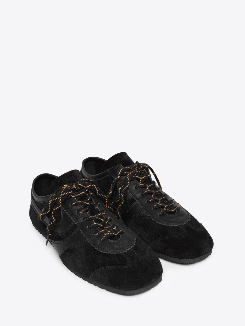 Pair of black suede sneakers on a white background