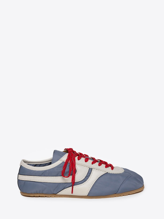 Blue and white suede sneaker with red laces on a white background