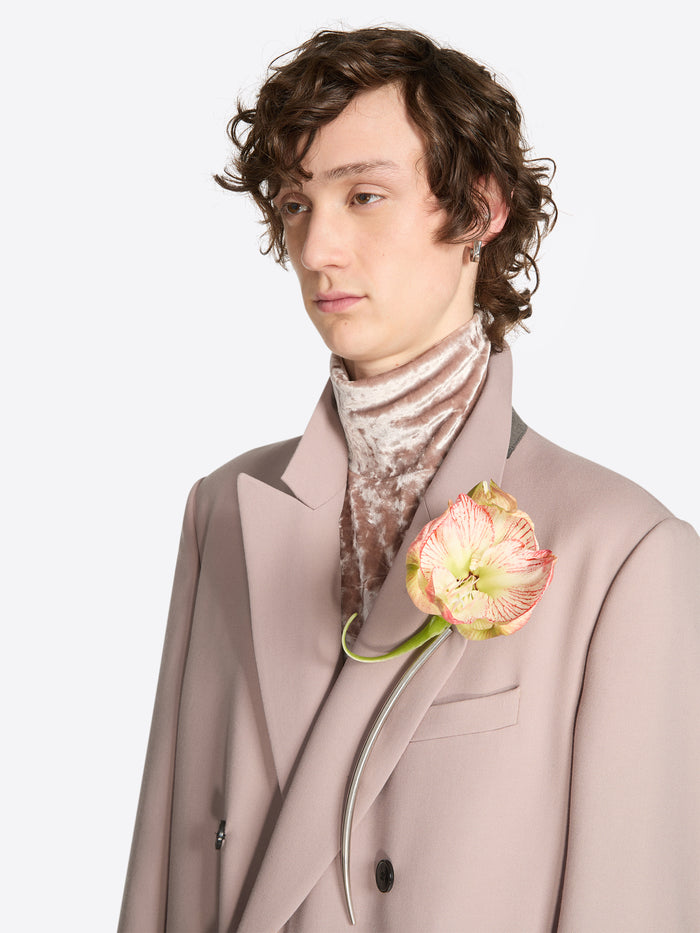 Person wearing a palladium clasp earring on a white background