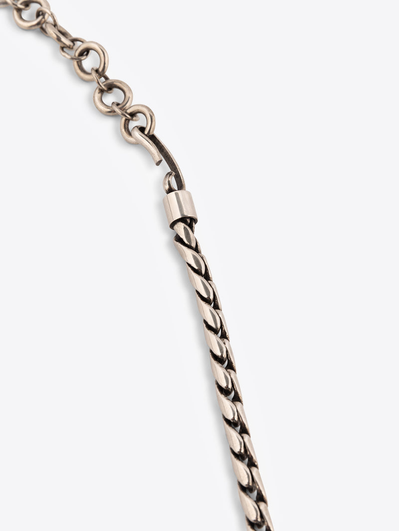 Close up of a palladium chain belt on a white background