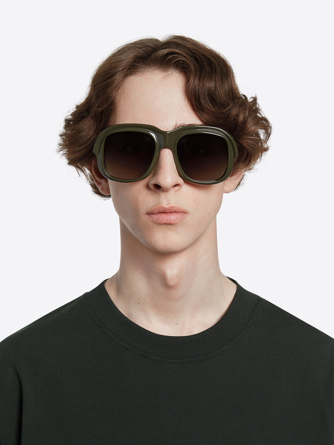 Person wearing oversized sunglasses on a white background