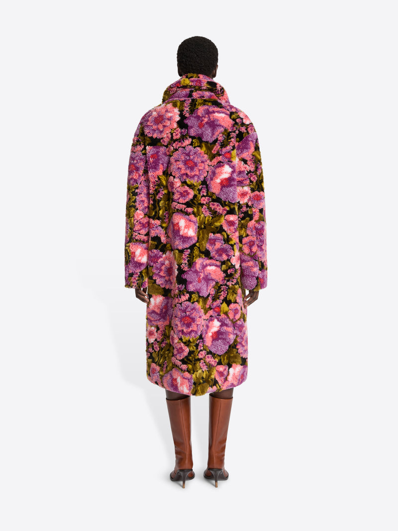 Mannequin wearing a floral coat on a white background