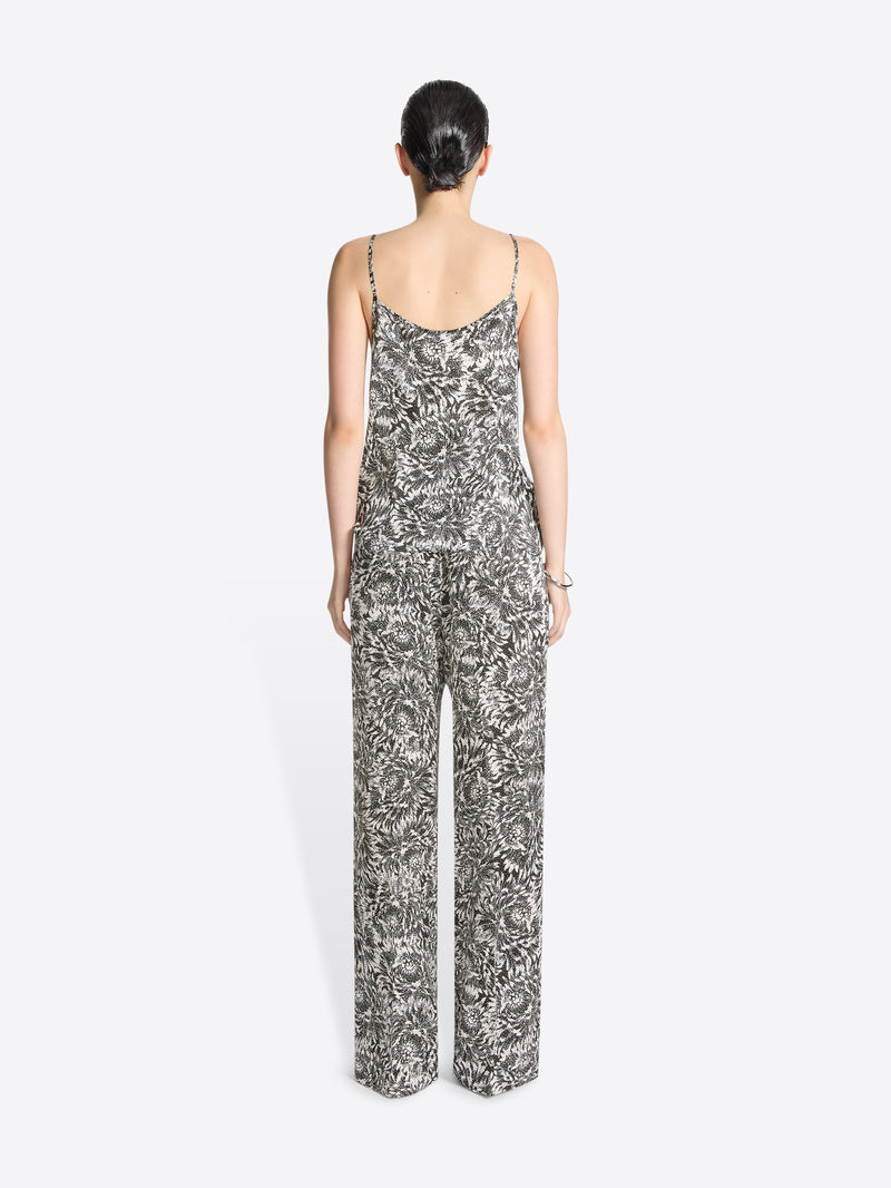 Woman wearing a floral jumpsuit on a white background