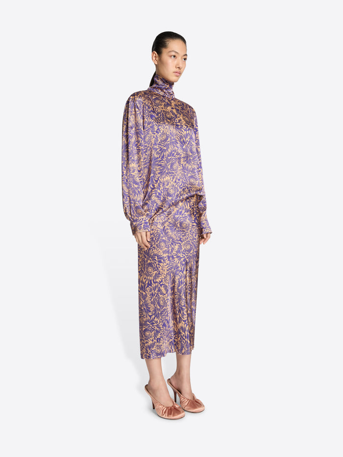 Woman wearing a patterned dress on a white background