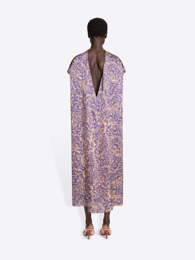 Purple floral dress worn by a model on a white background