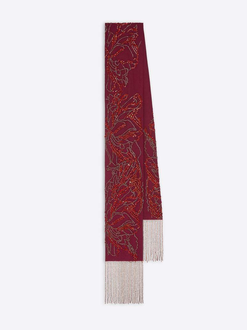 Decorative red and gold ribbon with white fringe on a white background