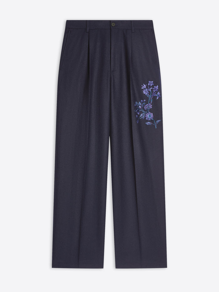 Navy pants with floral embroidery on a white background