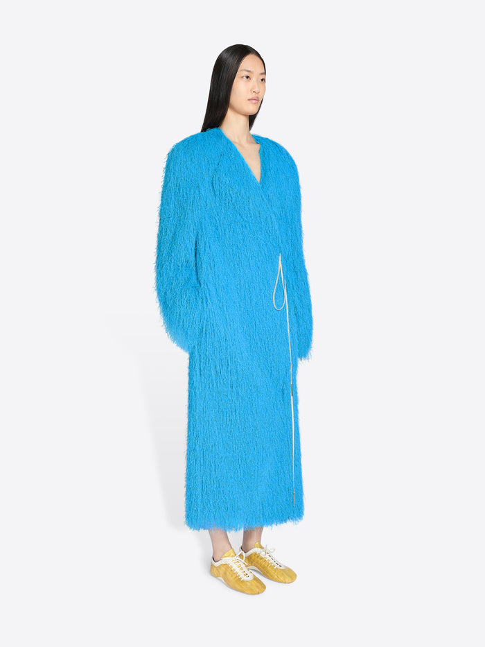 Person wearing a bright blue robe on a white background - Dries Van Noten