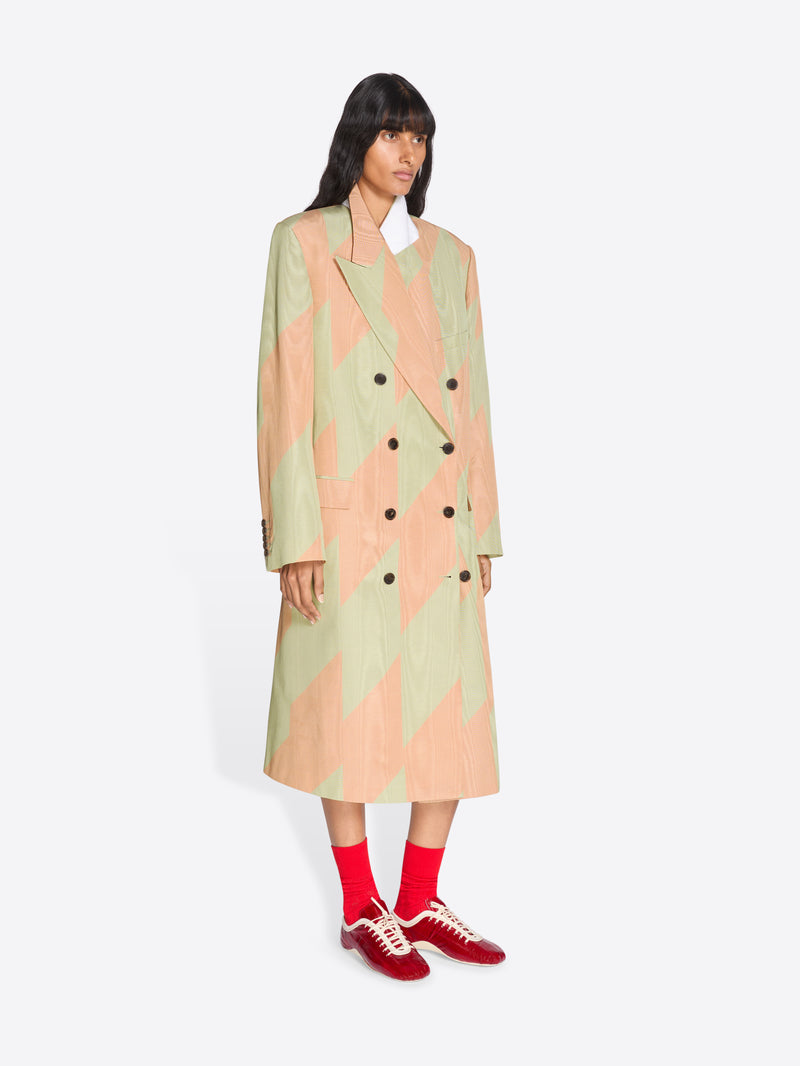 Person wearing a patterned coat with a white background - Dries Van Noten