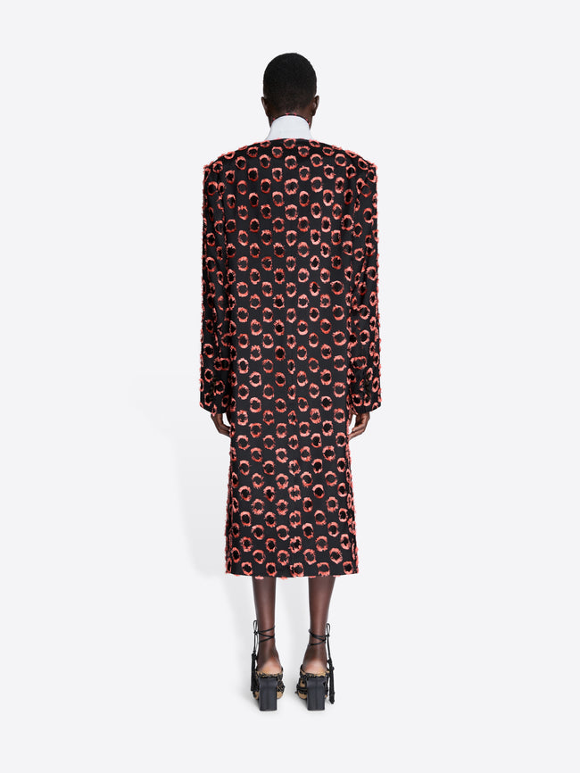 Person wearing a patterned coat on a white background - Dries Van Noten