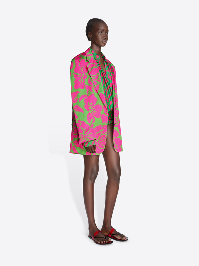 Model wearing a vibrant pink and green floral dress on a white background - Dries Van Noten