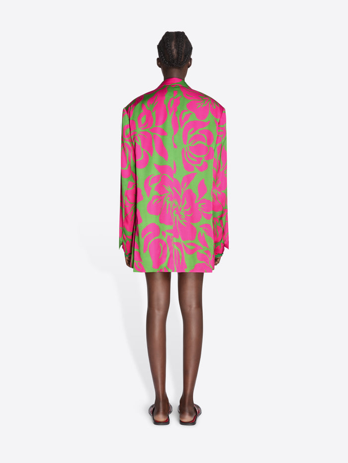 Person wearing a vibrant pink and green floral dress on a white background - Dries Van Noten