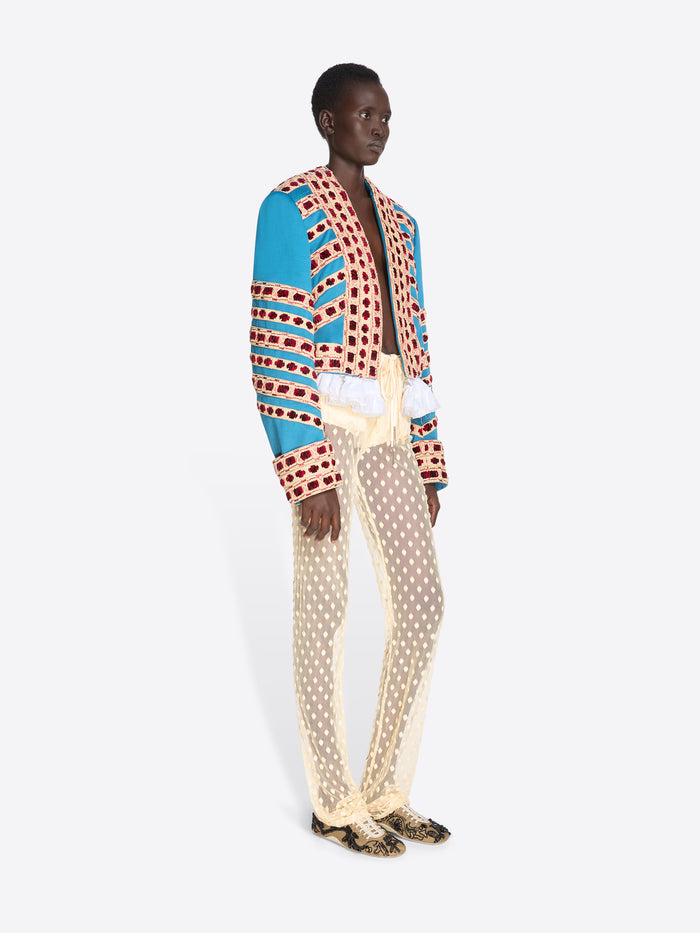 Model wearing a colorful patterned outfit with a white background - Dries Van Noten