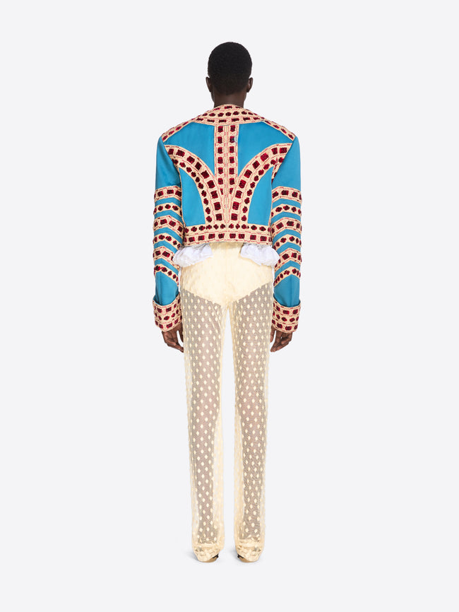 Person wearing a colorful patterned shirt with a white background - Dries Van Noten
