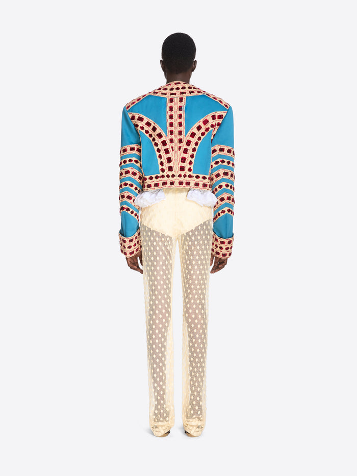 Person wearing a colorful patterned shirt with a white background - Dries Van Noten