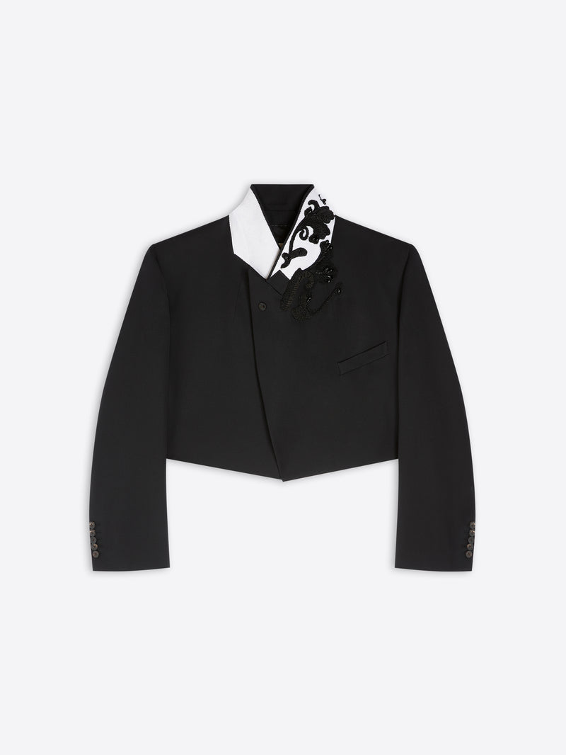 Black cropped tuxedo jacket with black and white patterned details on a light gray background - Dries Van Noten