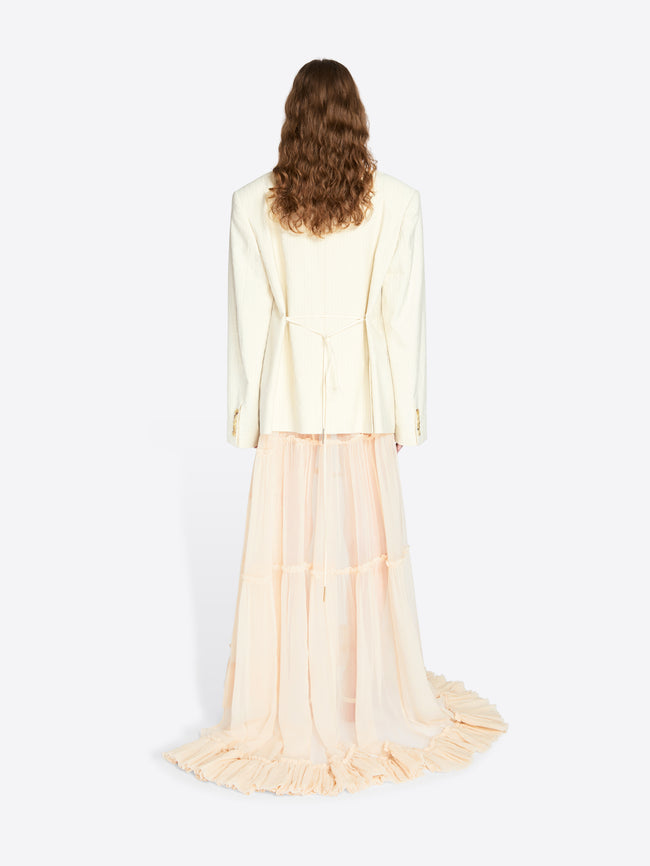 Woman wearing a light-colored outfit with a long skirt on a white background - Dries Van Noten