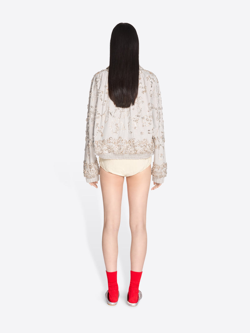 Person wearing a sheer top and red socks on a white background - Dries Van Noten