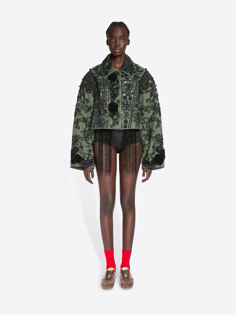 Model wearing a patterned green jacket on a white background - Dries Van Noten
