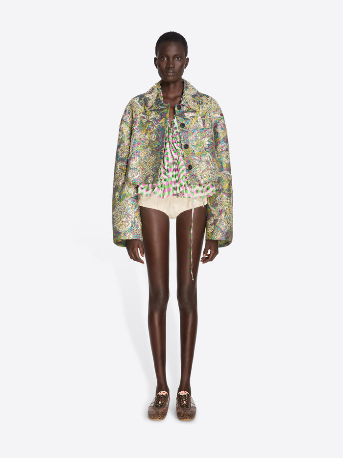Model wearing a floral jacket and white shorts on a white background - Dries Van Noten