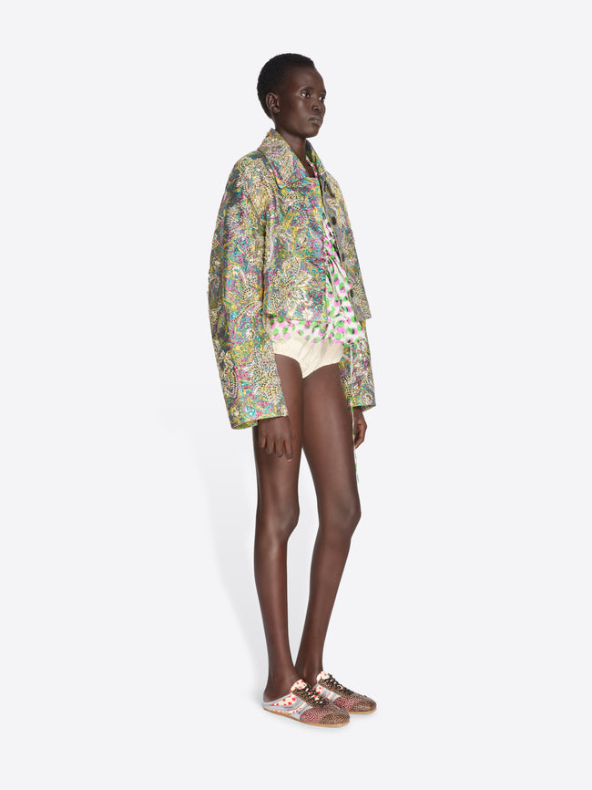 Model wearing a colorful floral jacket and shorts on a white background - Dries Van Noten