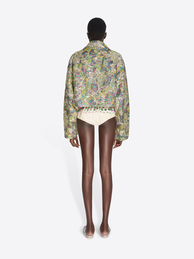 Person wearing a patterned shirt and white underwear shorts on a white background - Dries Van Noten