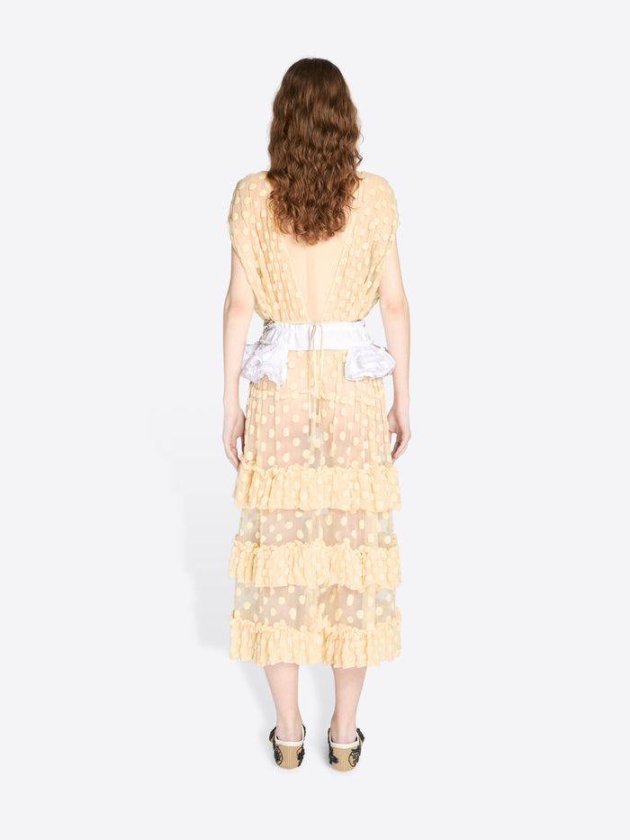 Woman wearing a light yellow dress with ruffled layers on a white background - Dries Van Noten