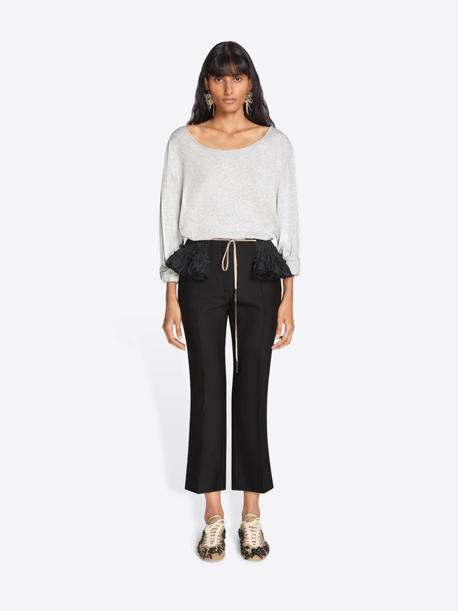 Woman wearing a white top and black pants on a white background - Dries Van Noten