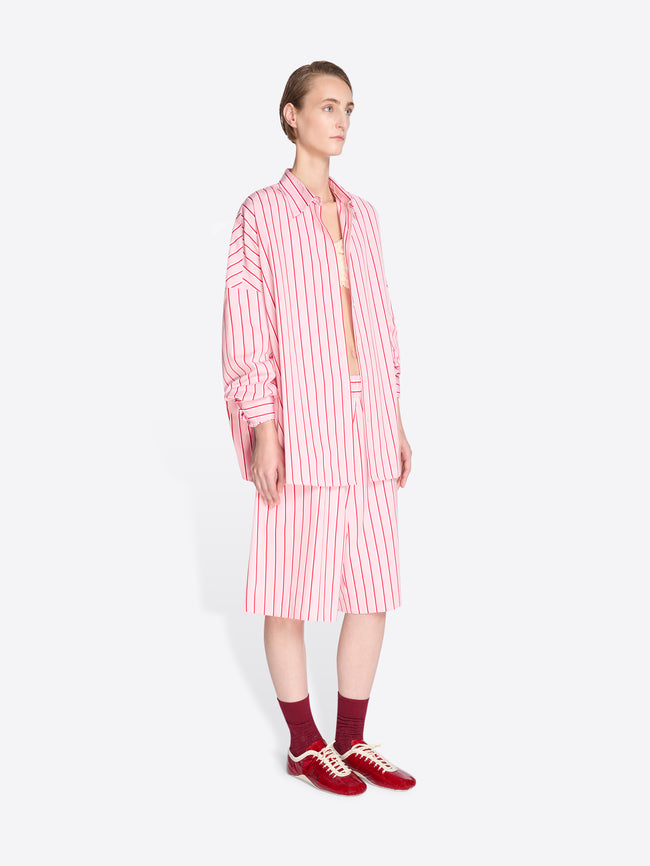 Woman wearing a pink and white striped outfit on a white background - Dries Van Noten