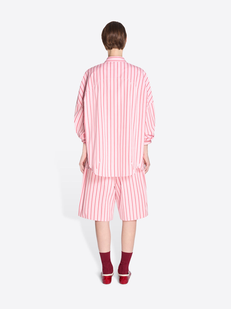 Person wearing a pink and white striped outfit on a white background - Dries Van Noten
