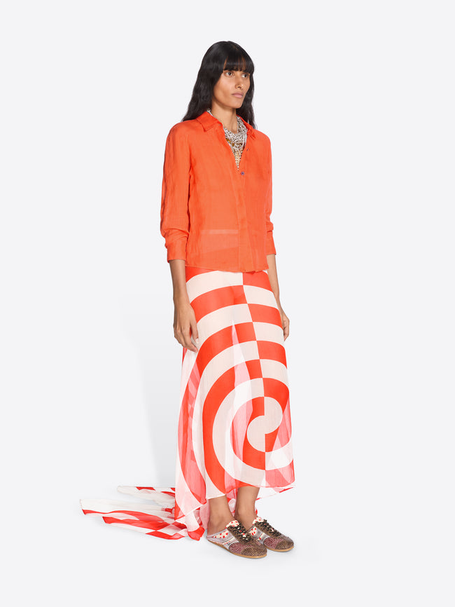 Woman wearing an orange top and red and white striped skirt on a white background - Dries Van Noten