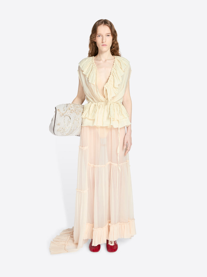 Woman wearing a light yellow dress with sheer overlay on a white background - Dries Van Noten