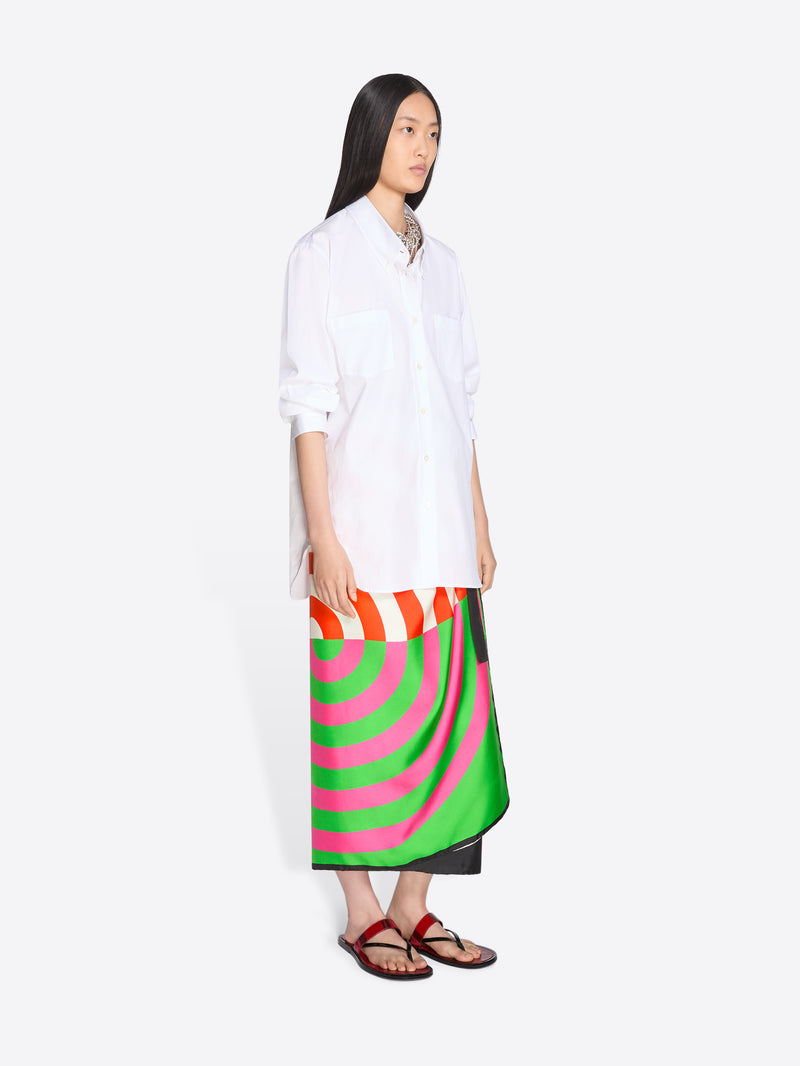 Woman wearing a white shirt and colorful skirt on a white background - Dries Van Noten