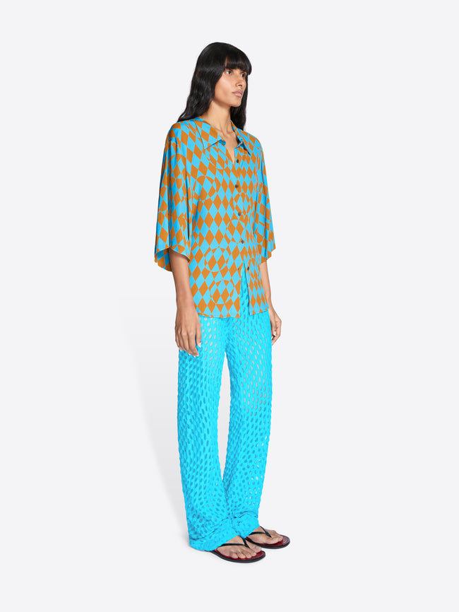 Woman wearing a blue and orange patterned outfit on a white background - Dries Van Noten