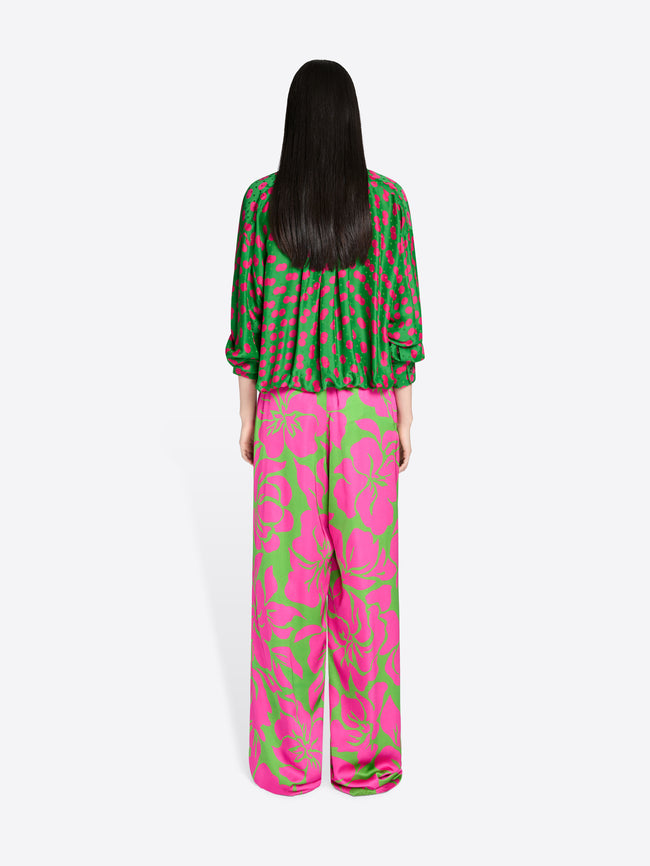 Person wearing a green and pink patterned outfit on a white background - Dries Van Noten