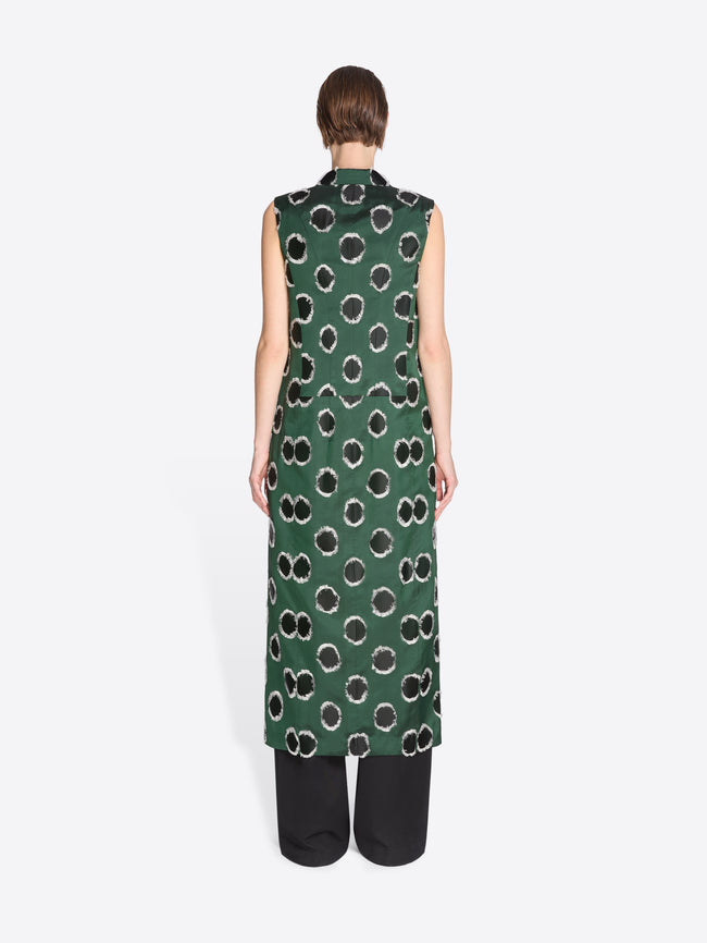 Person wearing a green sleeveless dress with black pattern on a white background - Dries Van Noten