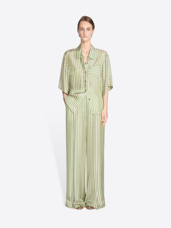 Woman wearing a green and white striped outfit on a white background - Dries Van Noten