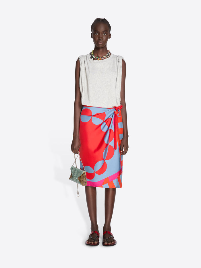 Model wearing a white sleeveless top and colorful skirt on a white background - Dries Van Noten