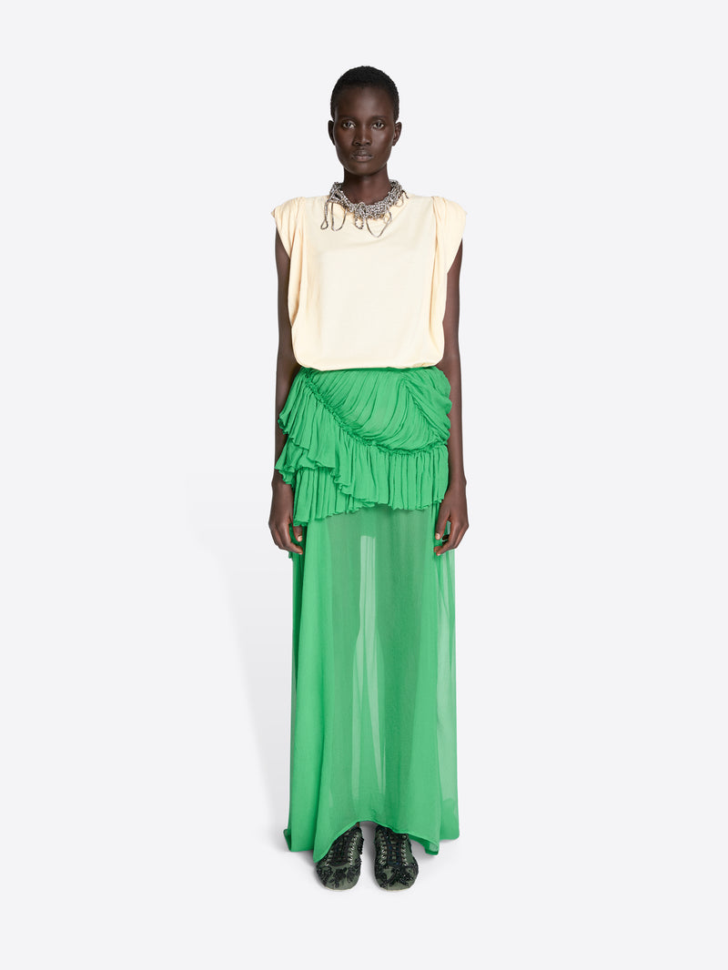 Model wearing a cream sleeveless top and green ruffled skirt on a white background - Dries Van Noten