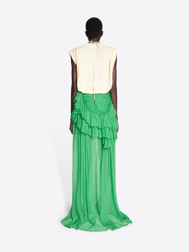Person wearing a green ruffled skirt and cream top on a white background - Dries Van Noten