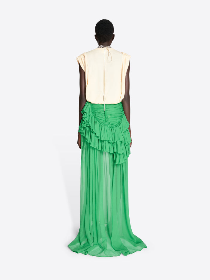 Person wearing a green ruffled skirt and cream top on a white background - Dries Van Noten