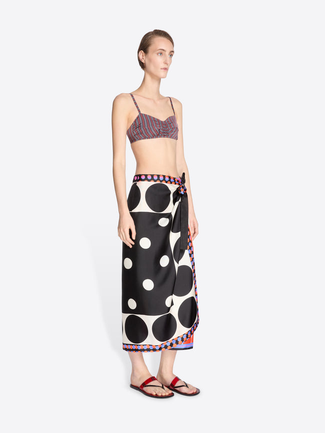 Woman wearing a patterned top and black polka dot skirt on a white background - Dries Van Noten