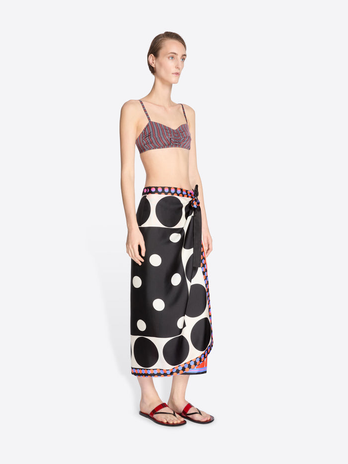 Woman wearing a patterned top and black polka dot skirt on a white background - Dries Van Noten